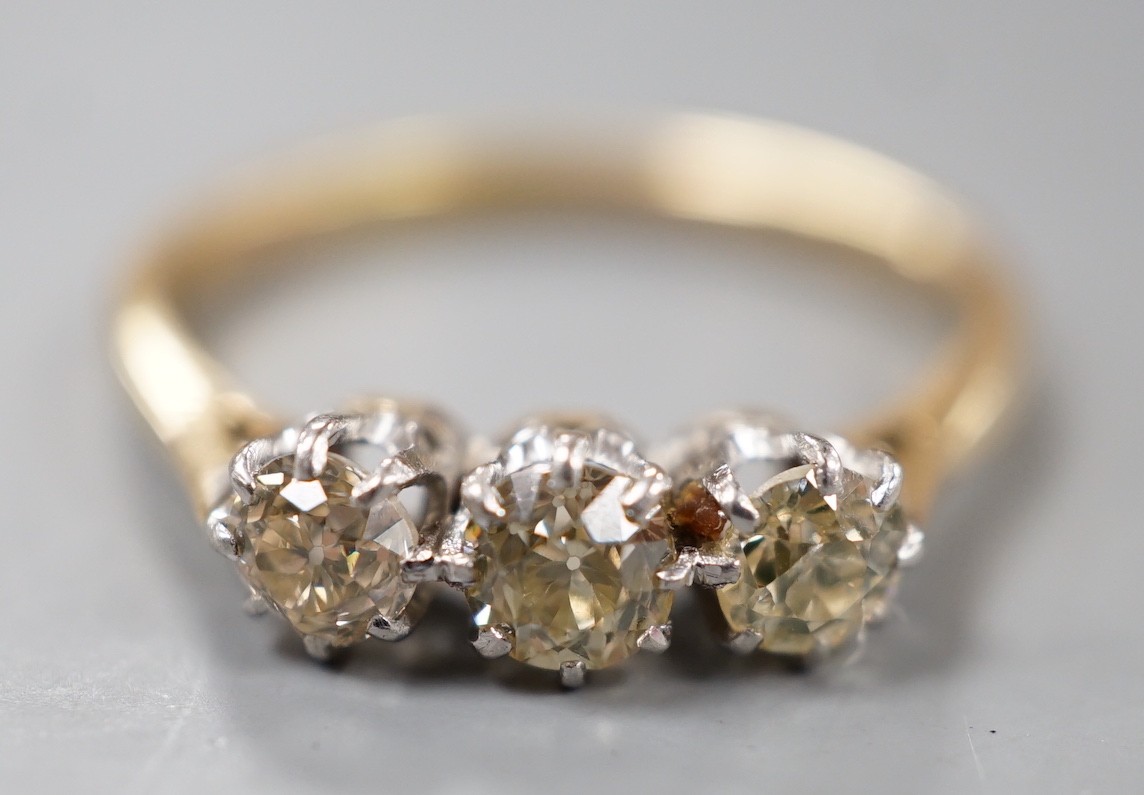 An 18ct and three stone diamond set ring, size P, gross weight 2.8 grams.